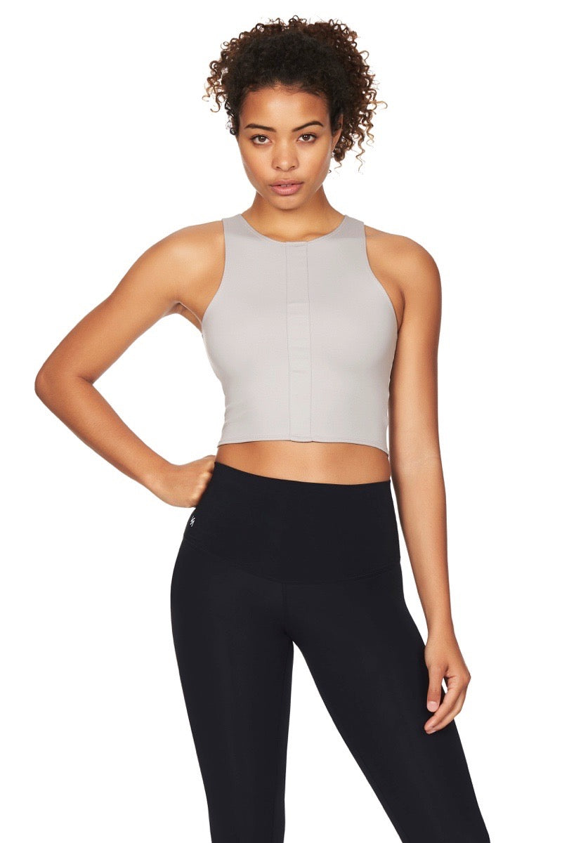 Model wearing grey crop top and black tights front view