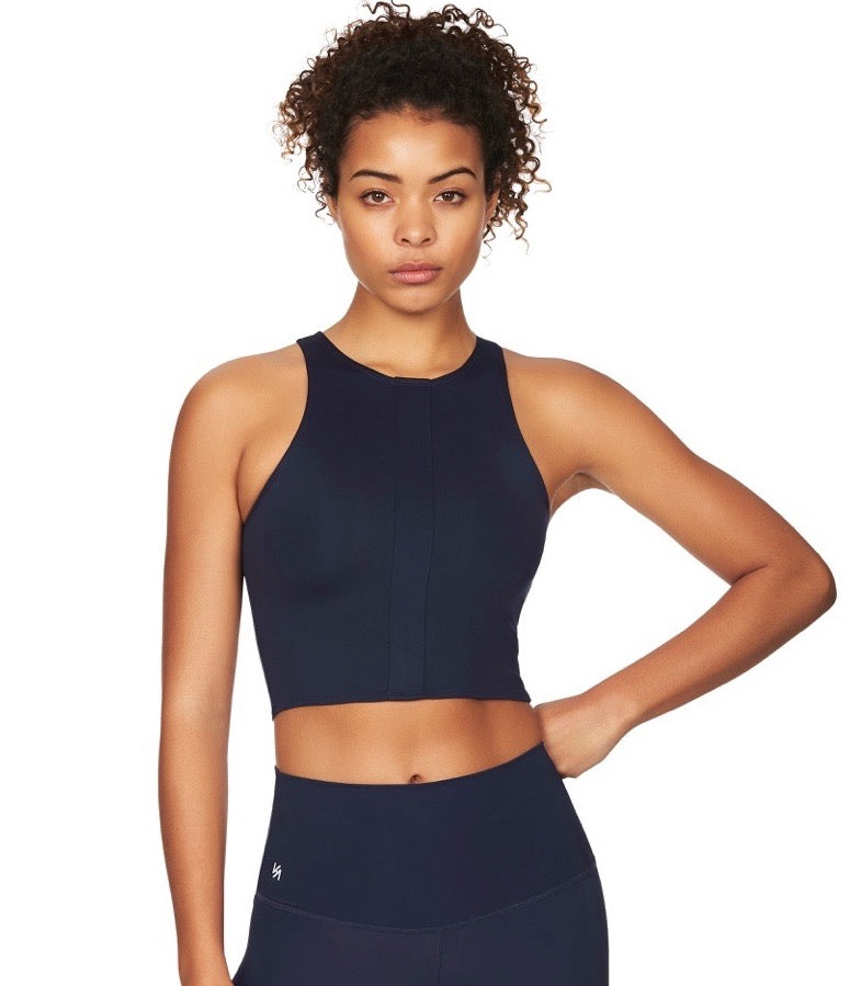Women wearing navy sports crop top with navy compression tights