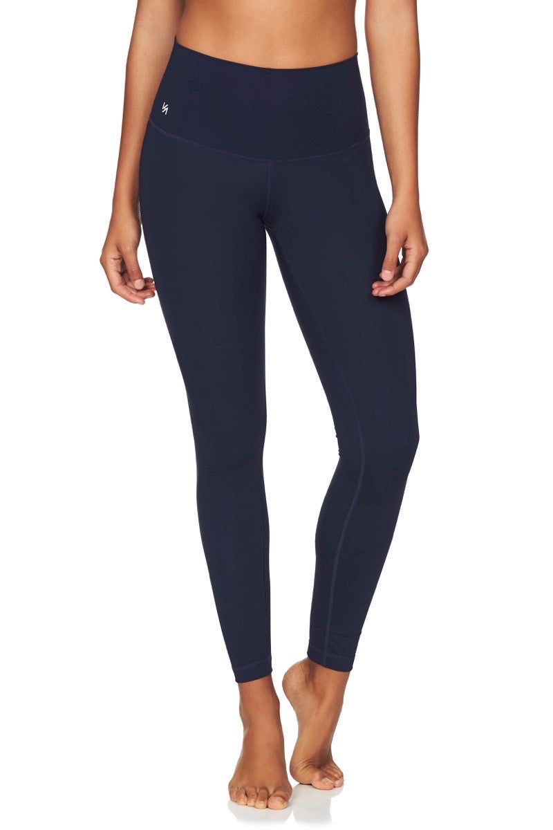 Front view of model wearing high waisted navy compression yoga pants 