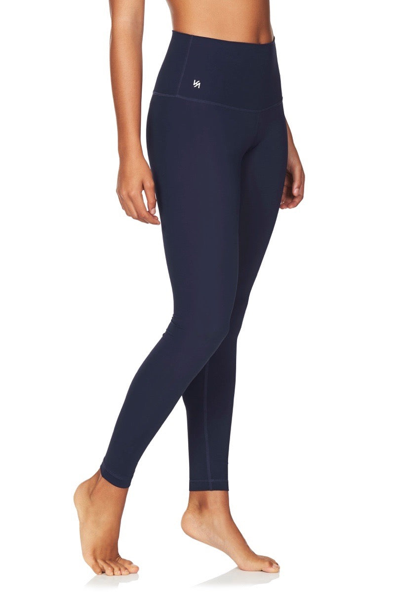Side view of model wearing navy high waisted compression tights