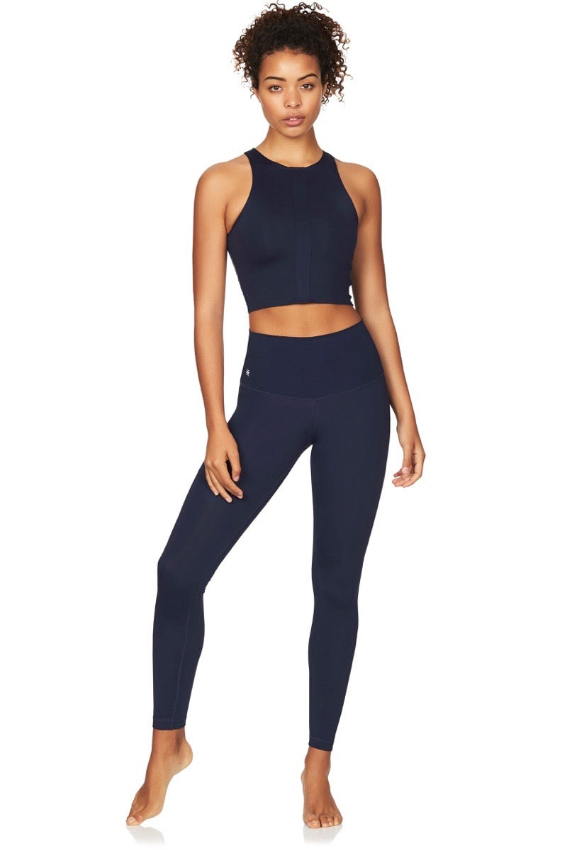 Model wearing navy crop top and navy compression yoga pants