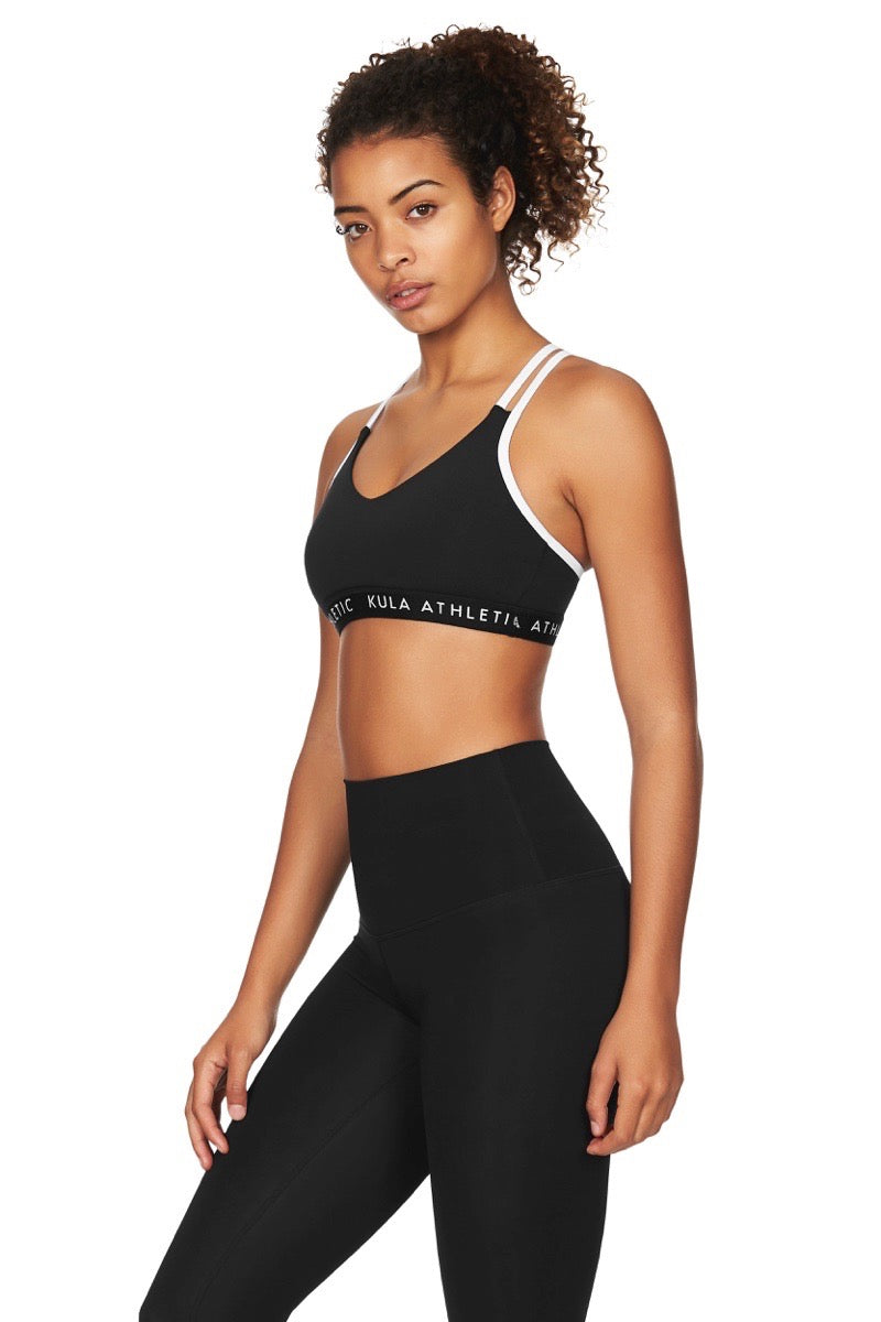 Model wearing black v-neck sports bra crop top with black compression leggings