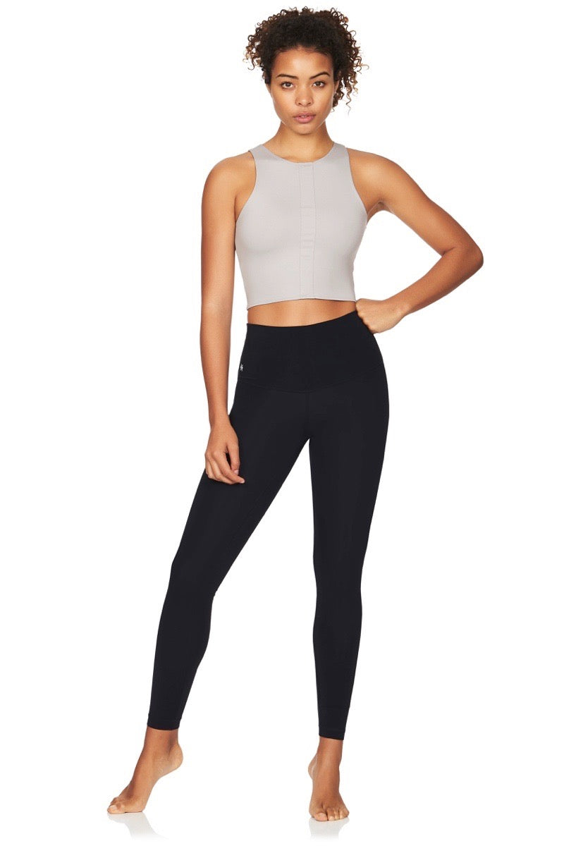 Model wearing grey sport crop top and black yoga pants