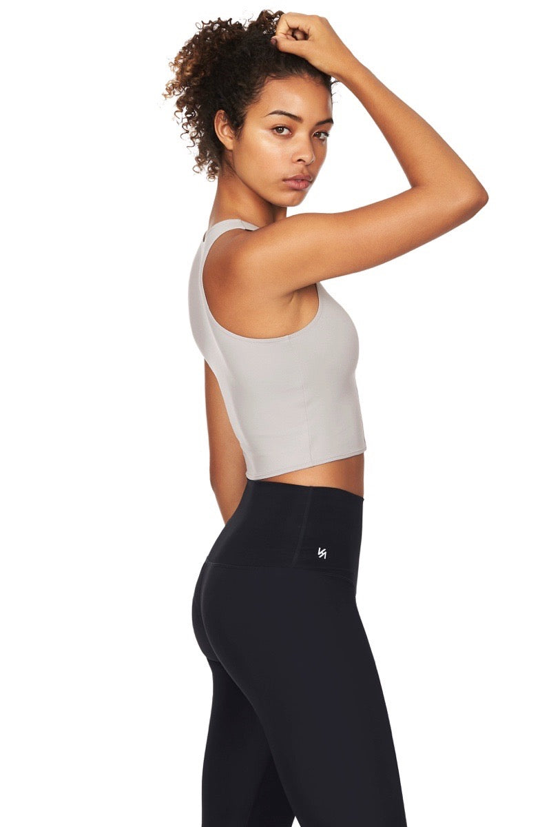 Model wearing grey crop top and black yoga pants side angle