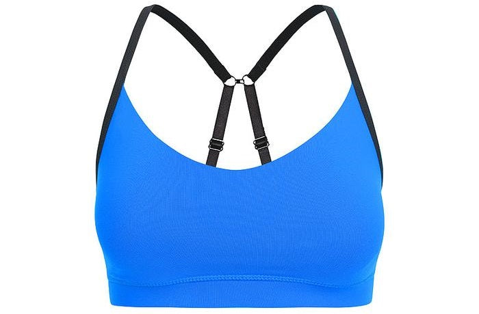 Blue sports bra with black strap details front view